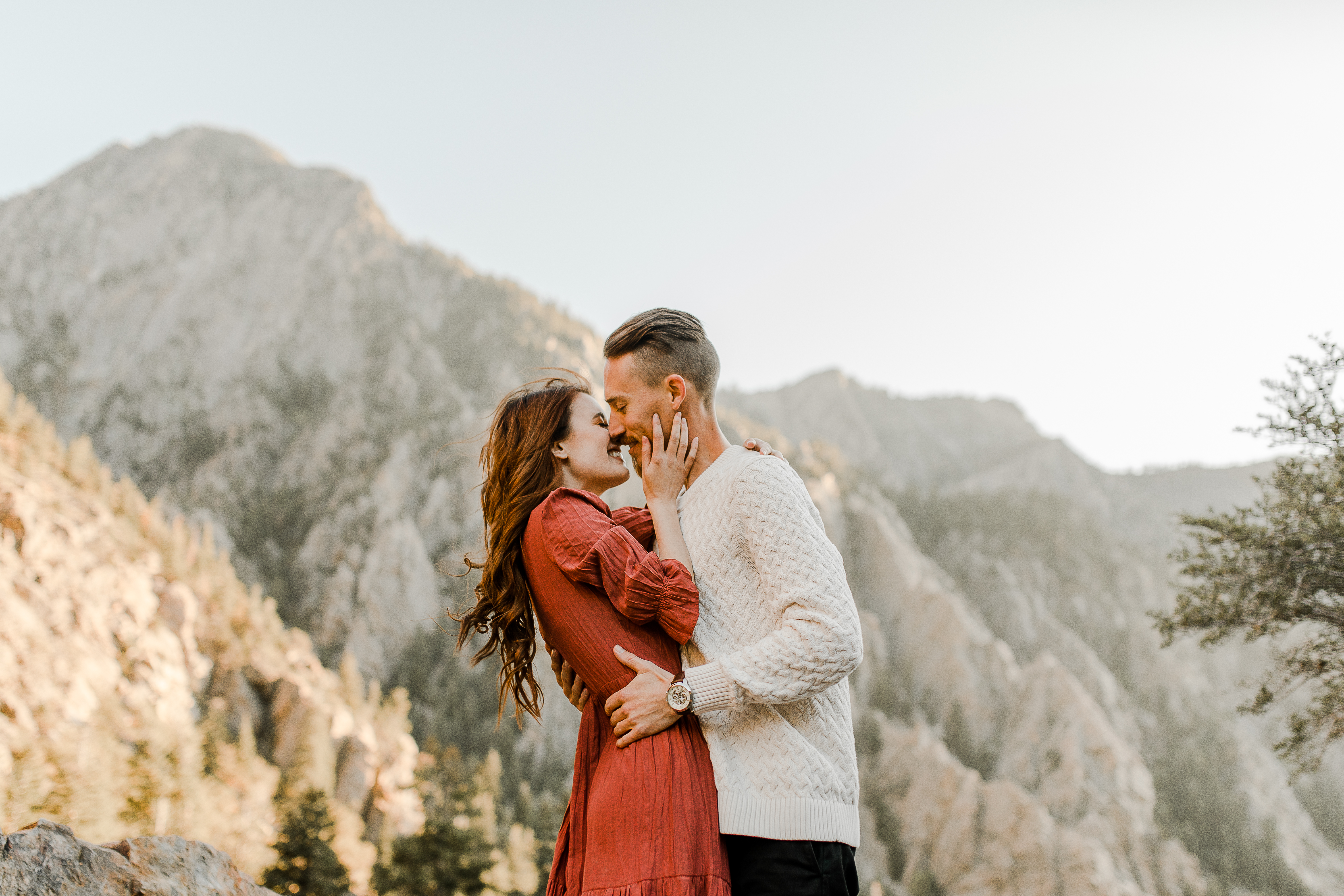 bride and groom kissing with a beautiful backdrop behind them during their Big Cottonwood Canyon Engagement Session