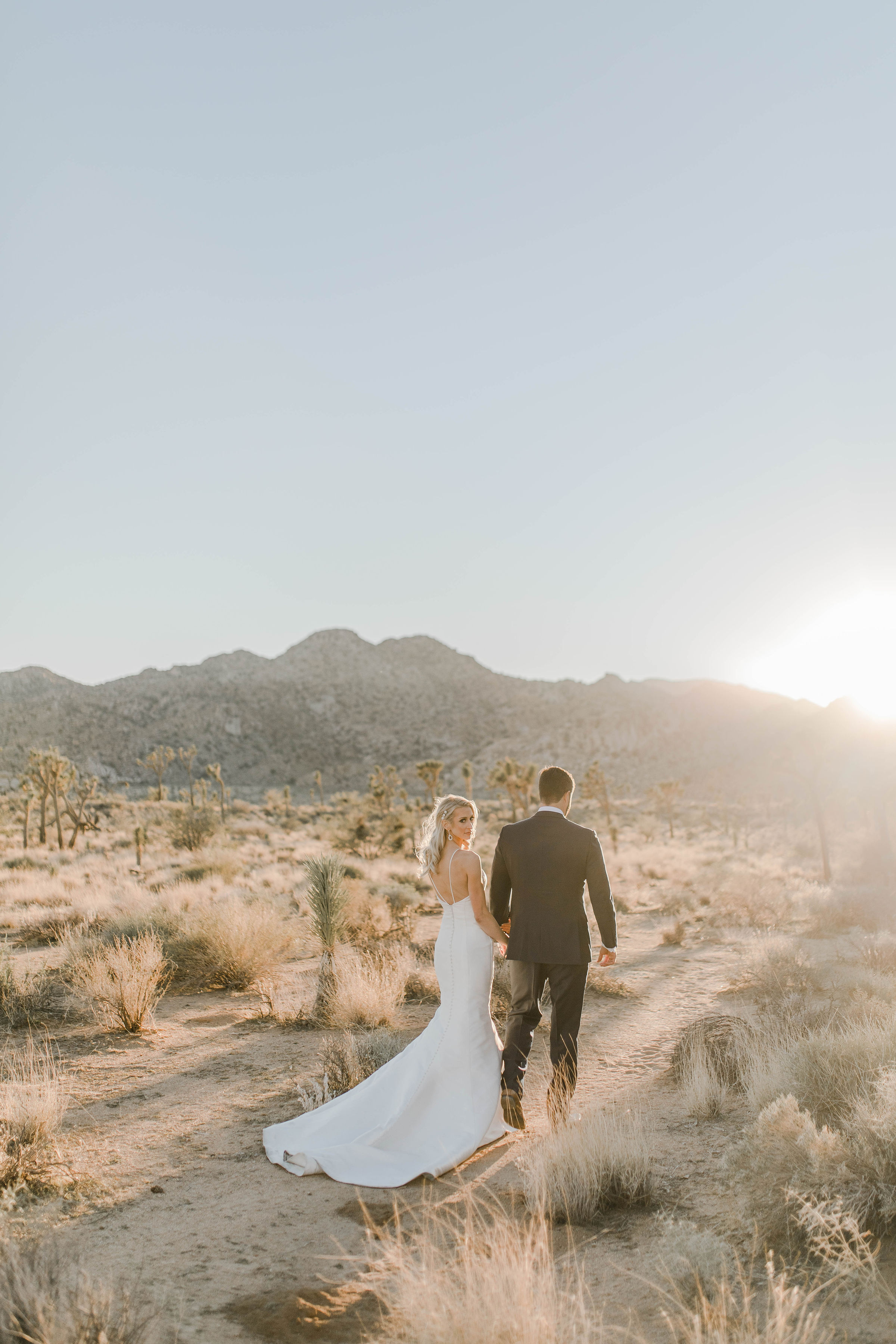 bride and groom taking pictures during a stunning joshua tree elopement