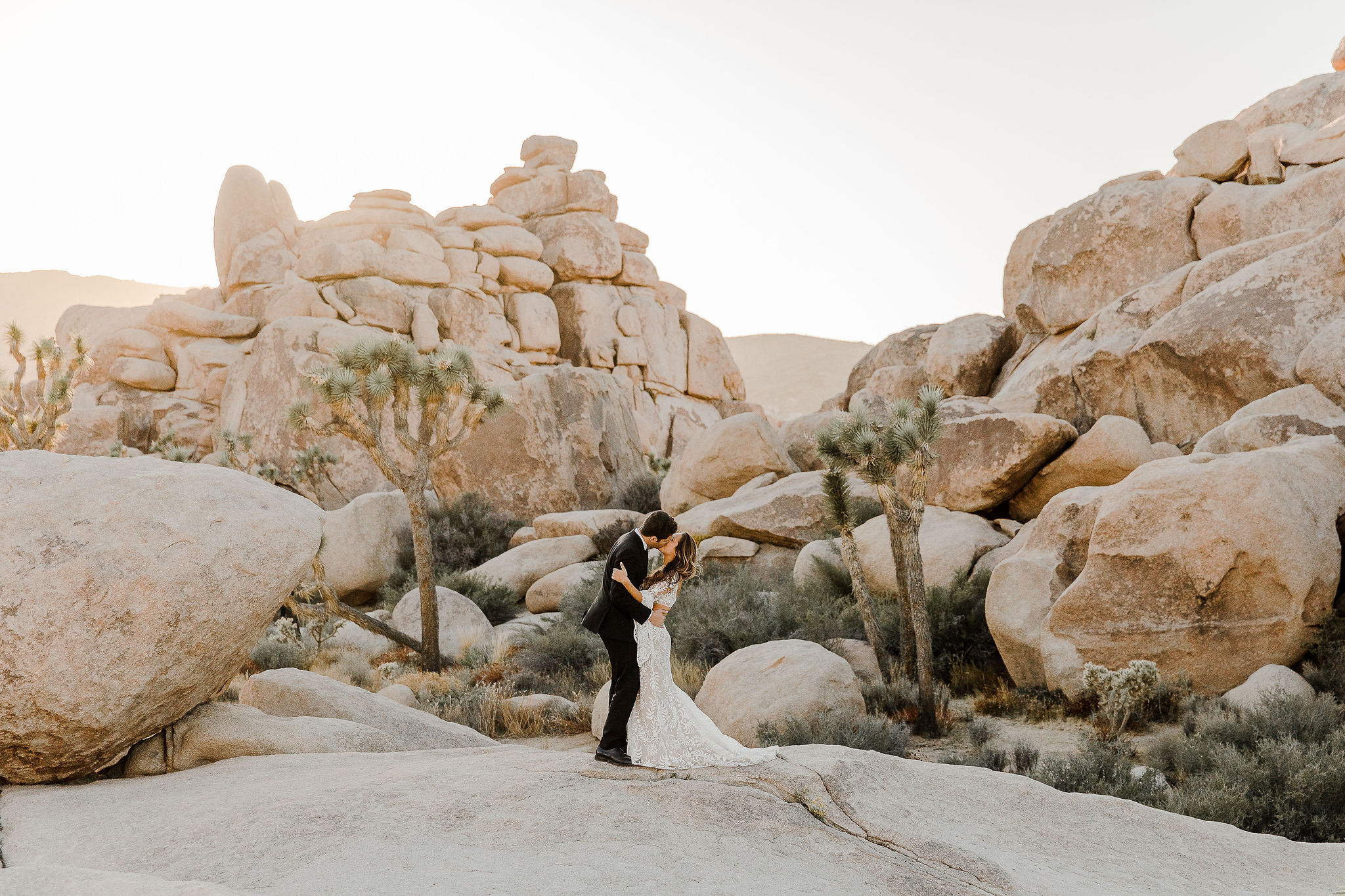 bride and groom taking pictures during a stunning joshua tree elopement