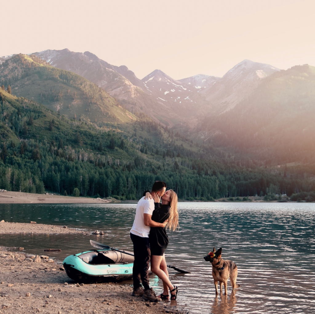 picture of a couple in the mountains. in the photo there is a dog and a kayak in a lake. The only list you need for ideas on how not to be stressed! 100+ ideas to help you enjoy the positive vibes in your life!